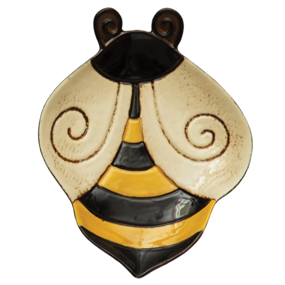 A hand-painted, bee-shaped stoneware plate featuring cream wings and yellow and black stripes.
