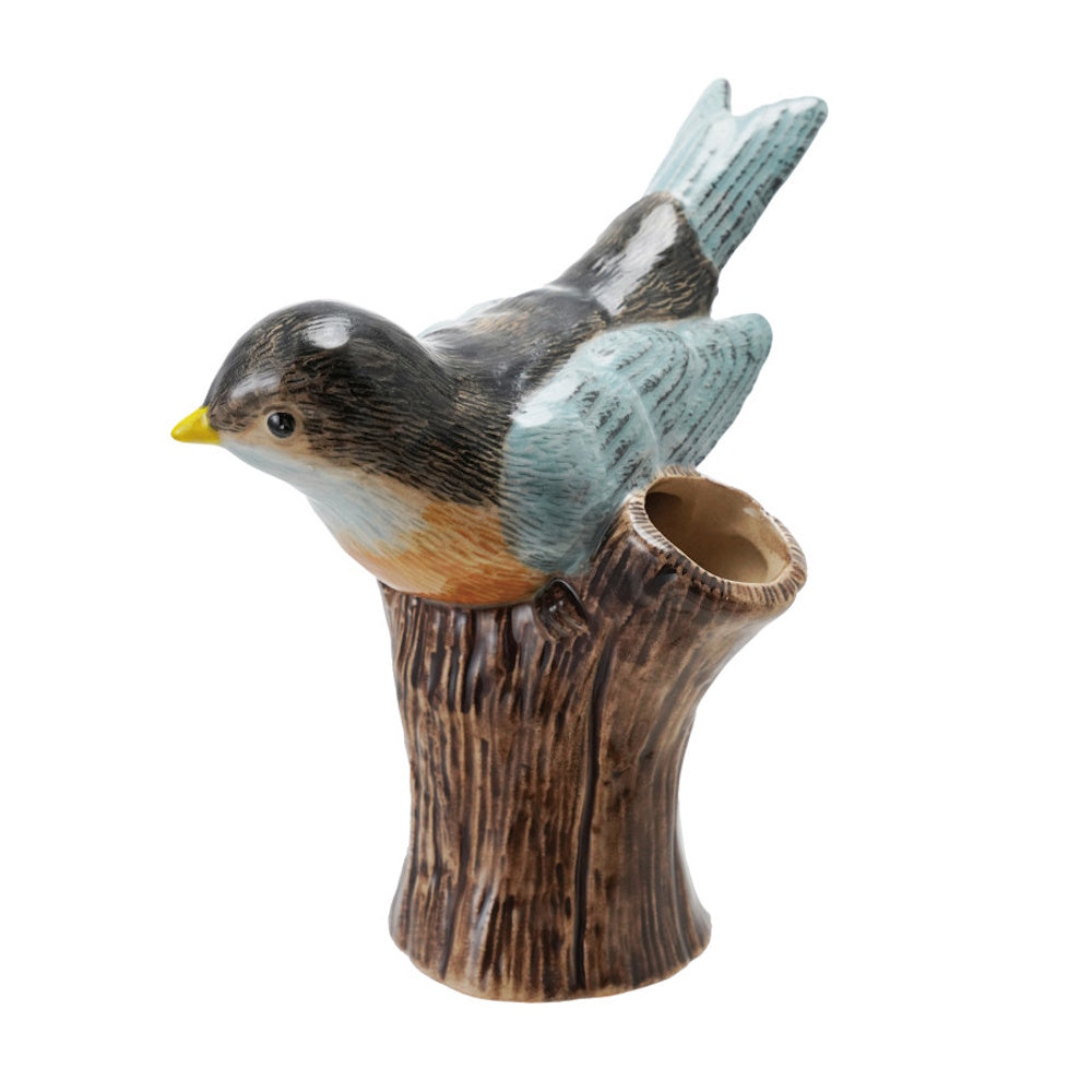 Hand-painted stoneware bird perched on a brown log-shaped vase with a hollow opening.