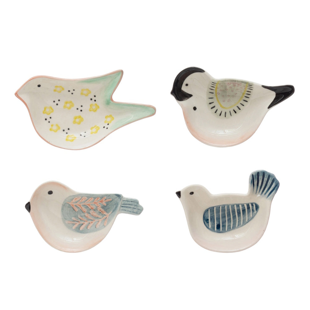 Four small, hand-painted stoneware dishes shaped like birds, each with a unique colorful design on a white base.