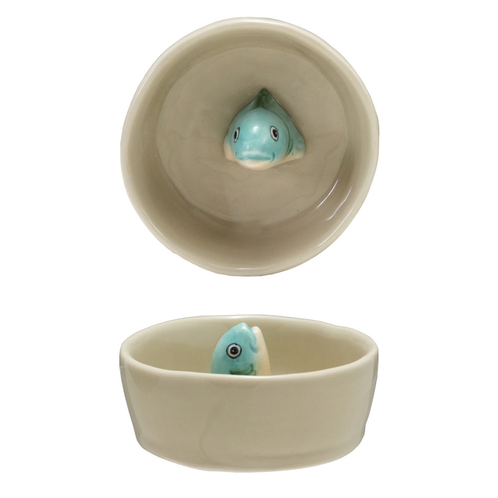 Top and side views of a small ceramic bowl featuring a 3D blue fish figure emerging from the bottom.