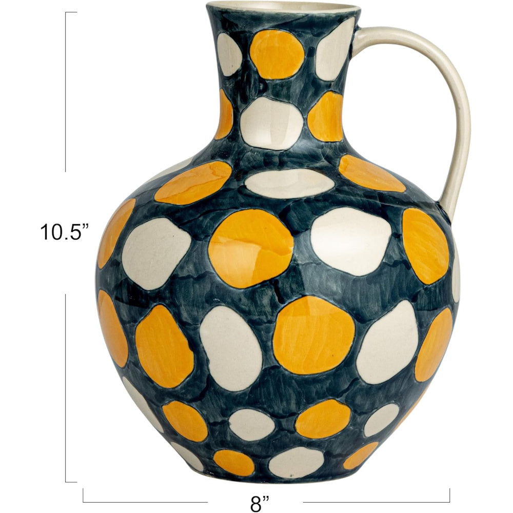 10.5 inch tall ceramic pitcher with yellow and white polka dots on a dark teal glaze, 8 inches wide.