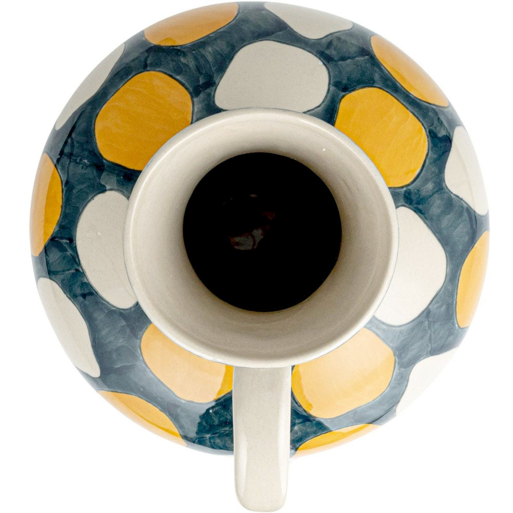 Top-down view of a ceramic vase featuring a hand-painted yellow, white, and gray pebble pattern on a white background.