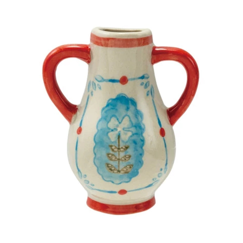 Cream ceramic vase with two red handles, blue floral designs, and red trim on a white background.