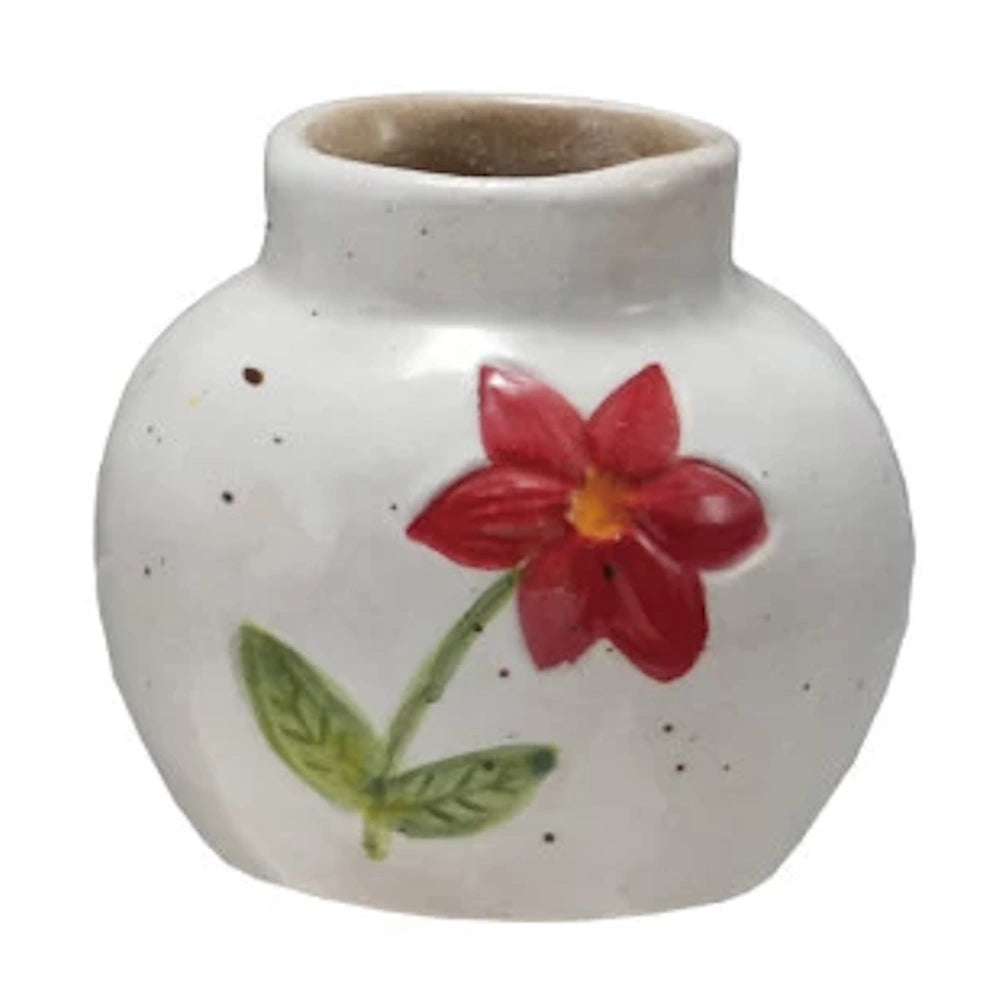 Hand-painted white stoneware bud vase with a red flower and green leaves on a speckled ceramic background.