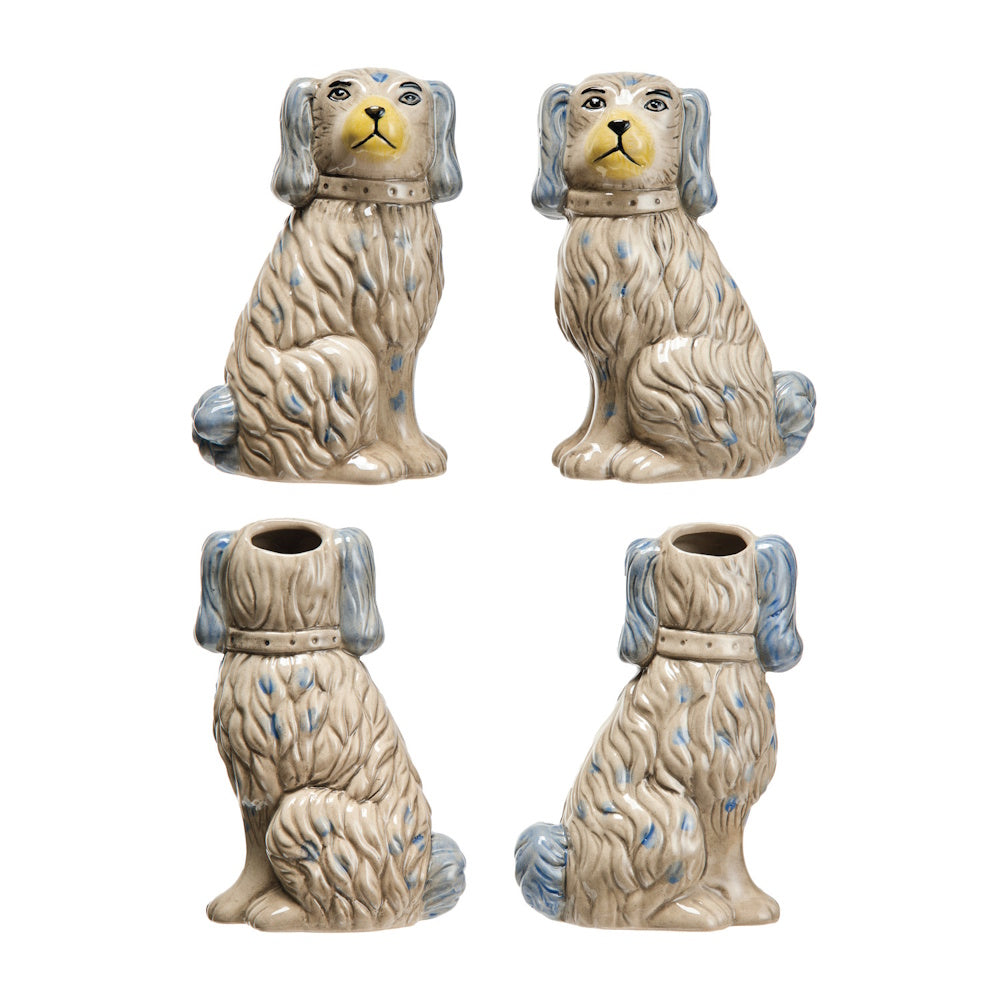 Set of two vintage-style Staffordshire dog vases with hand-painted blue details and yellow snouts on a white background.