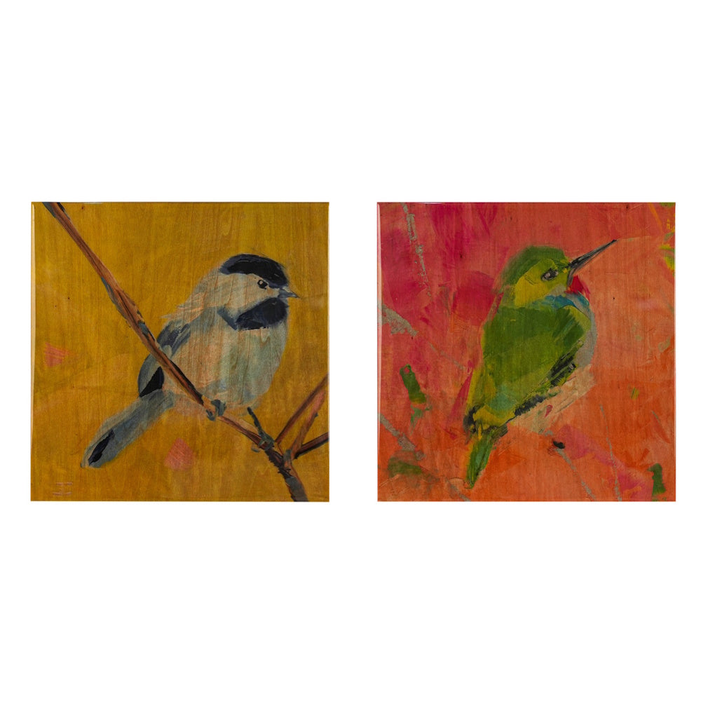 Two square wooden panels featuring hand-painted birds: a chickadee on a gold background and a green bird on orange.