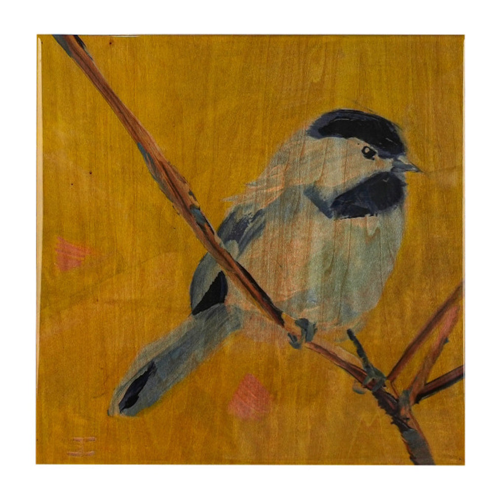 A hand-painted chicadee bird with a black cap and throat, perched on a branch against a golden wood background.