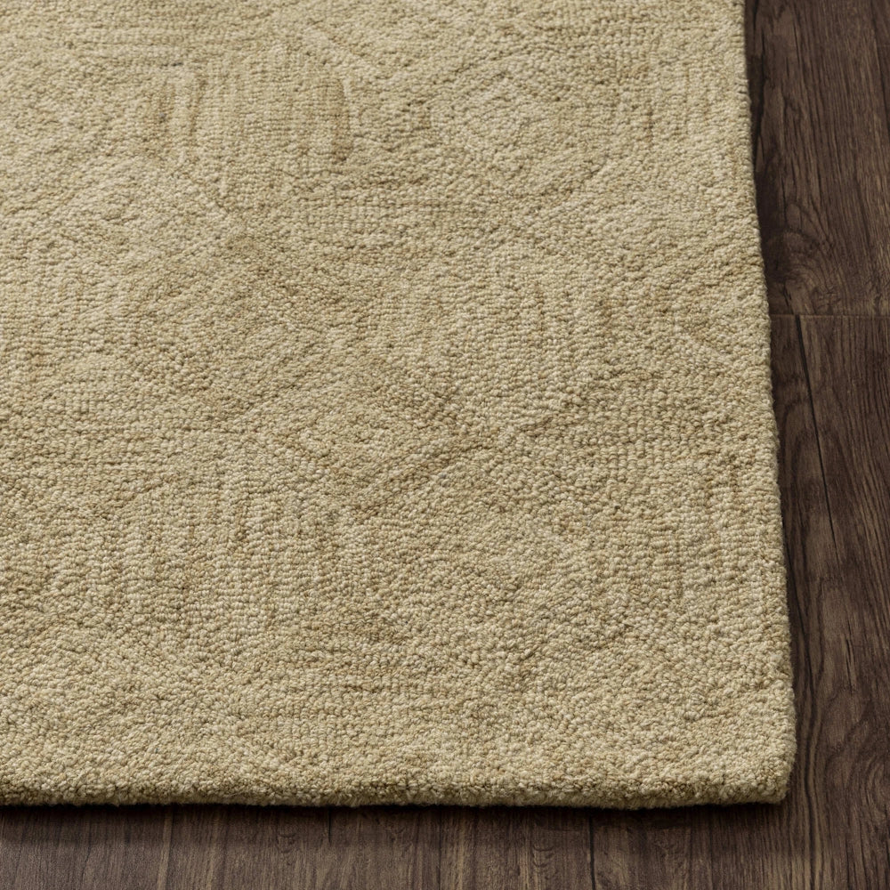 Beige hand tufted rug corner with subtle geometric pattern, textured pile and clean finished edges.