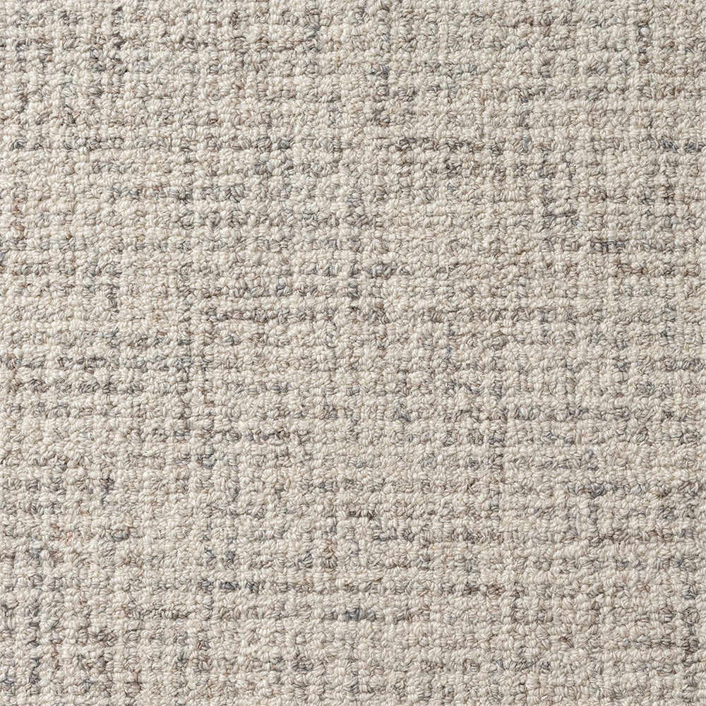 Neutral beige and grey textured loop pile carpet with a modern woven geometric pattern for home flooring.