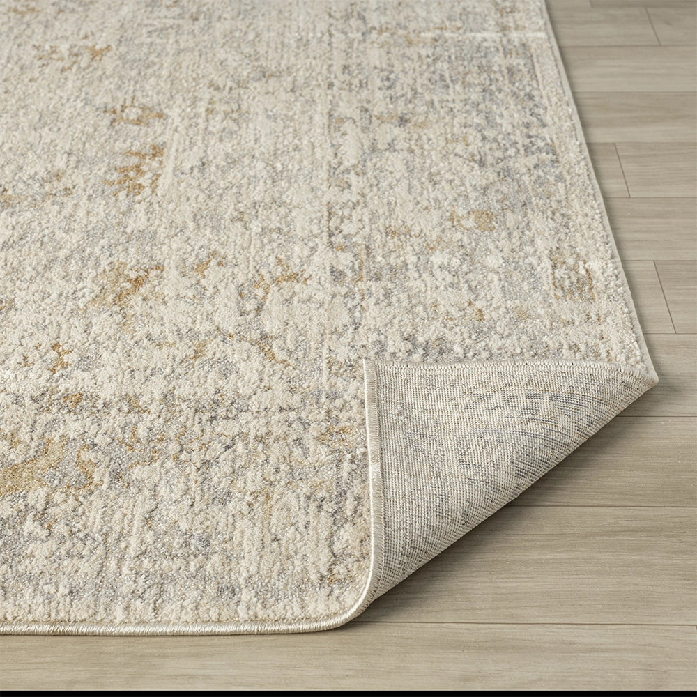 Close-up of a hand-tufted Monaco rug showing its textured beige and grey pile and durable non-slip backing.