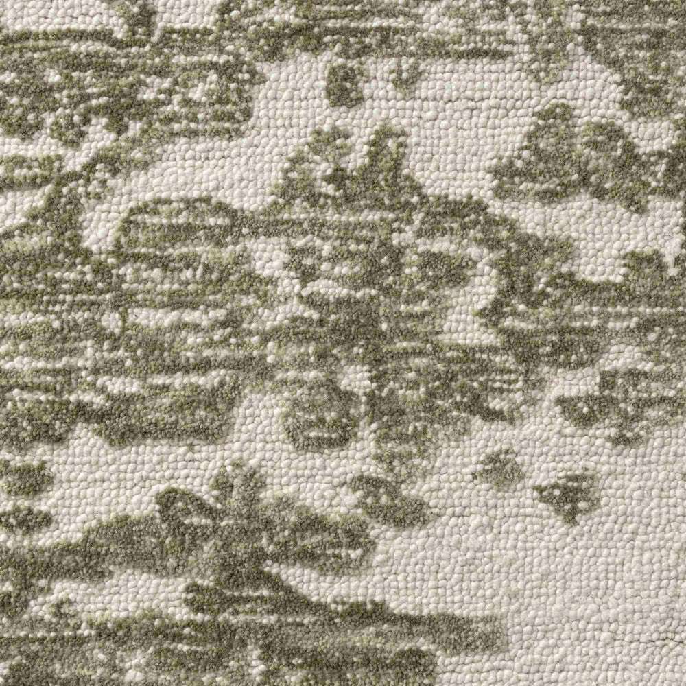 Close up of green and ivory hand tufted rug with textured abstract pattern and soft raised pile detail.
