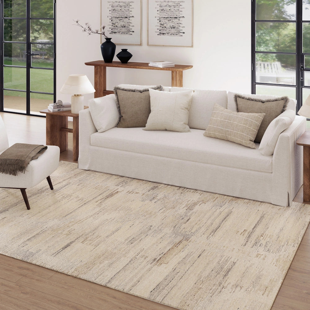 Cream hand tufted area rug in a modern living room with subtle abstract pattern and neutral contemporary style.