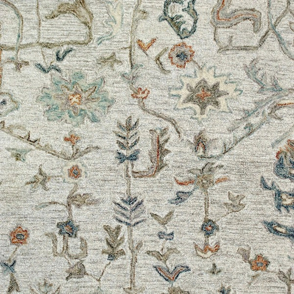 Ivory hand-tufted rectangle vintage rug with intricate floral pattern.