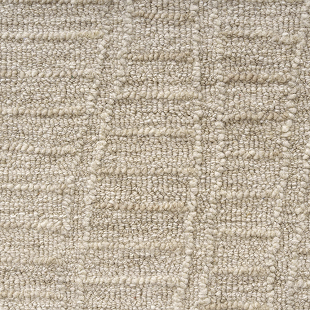 Close up of a beige hand tufted haze rectangle rug featuring a textured geometric pattern.
