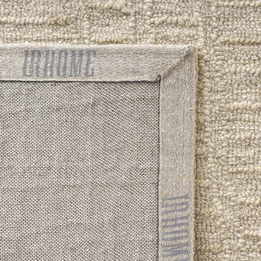 Backing corner of an LR Home hand tufted haze rectangle rug showing durable canvas backing and textured pile.