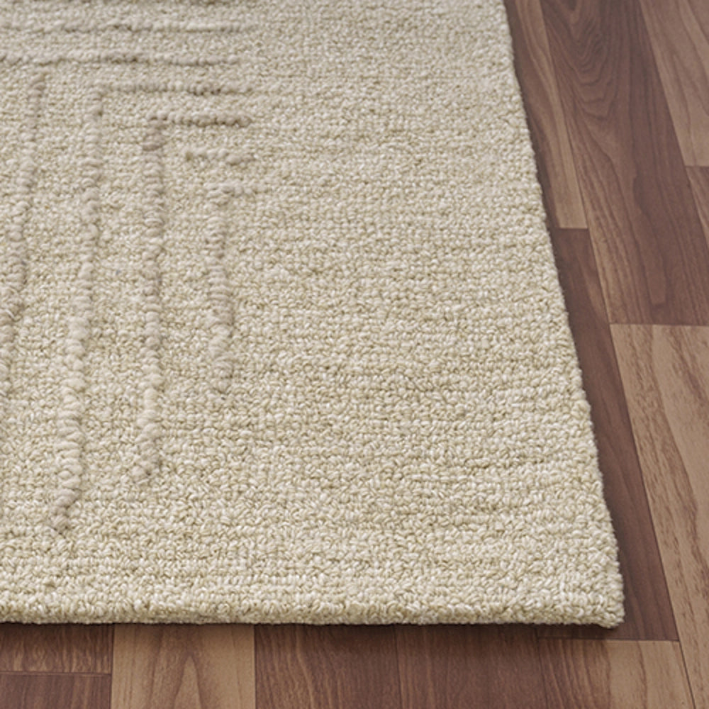 Close-up of a hand-tufted rectangle haze rug in oatmeal showing textured geometric details.