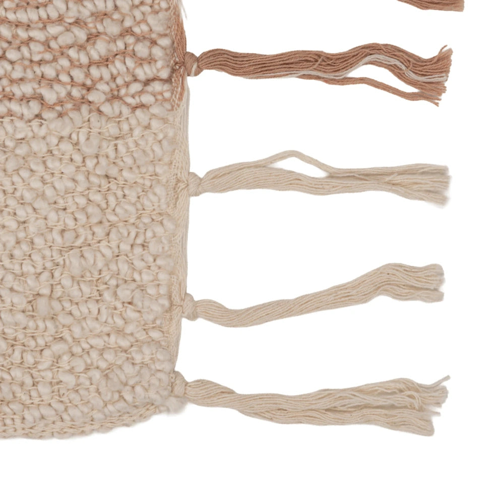 Close-up view of the fringe details on a multi-colored hand-woven cotton throw blanket.