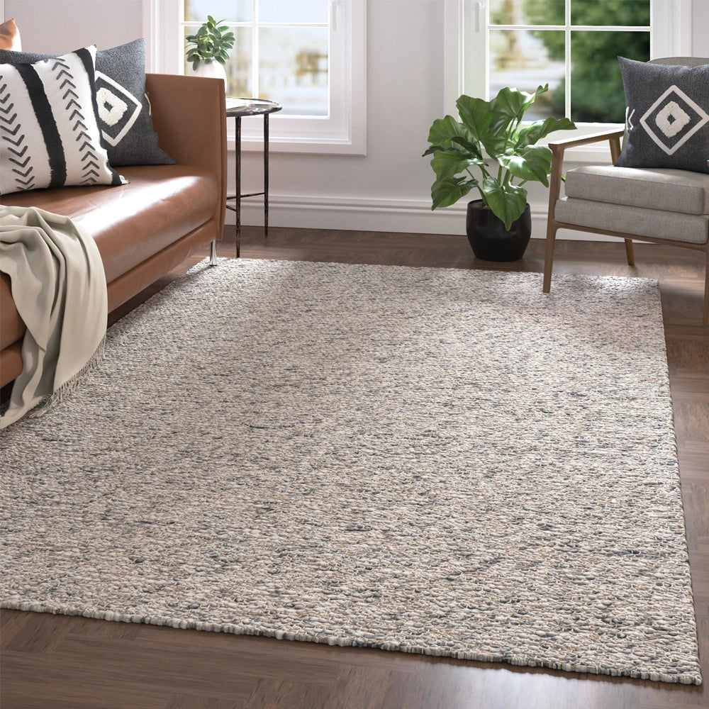 Hand-woven rectangle dome rug on a hardwood living room floor.