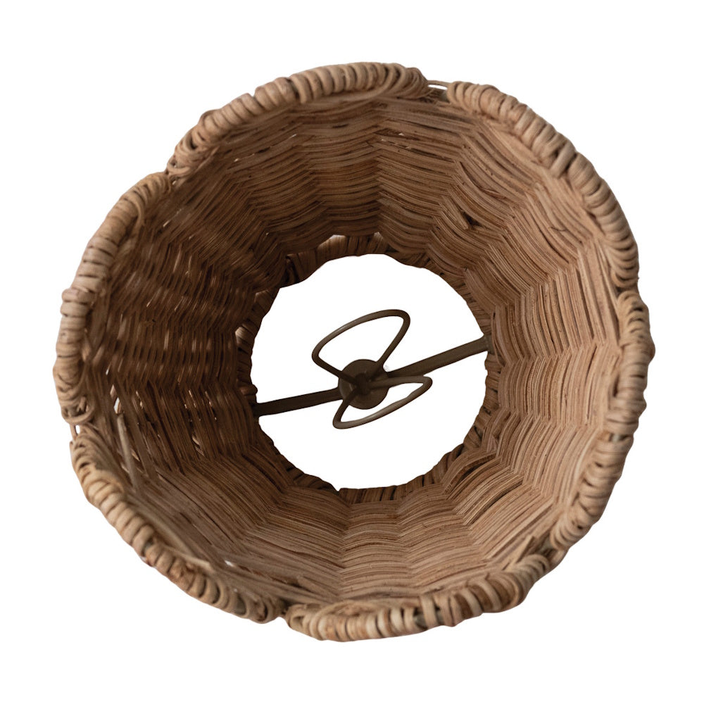 Interior view of a hand-woven seagrass lamp shade, showing the central metal clip-on bulb adapter.