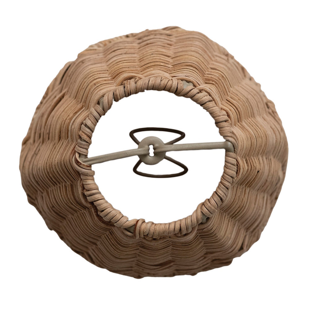 Top-down view of a round, hand-woven wicker lamp shade showing the inner metal clip-on adapter mechanism.