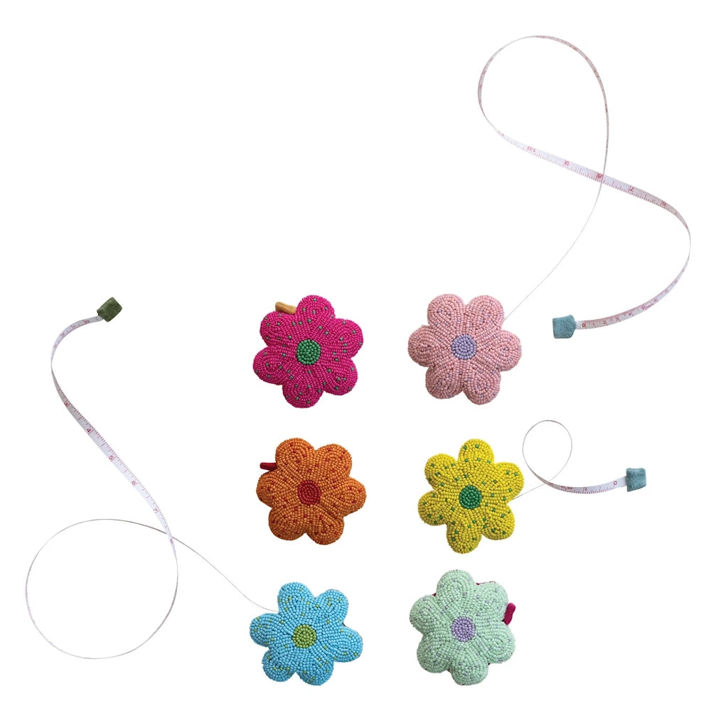 Handmade beaded flower tape measures in various colors including pink, orange, blue, and yellow.