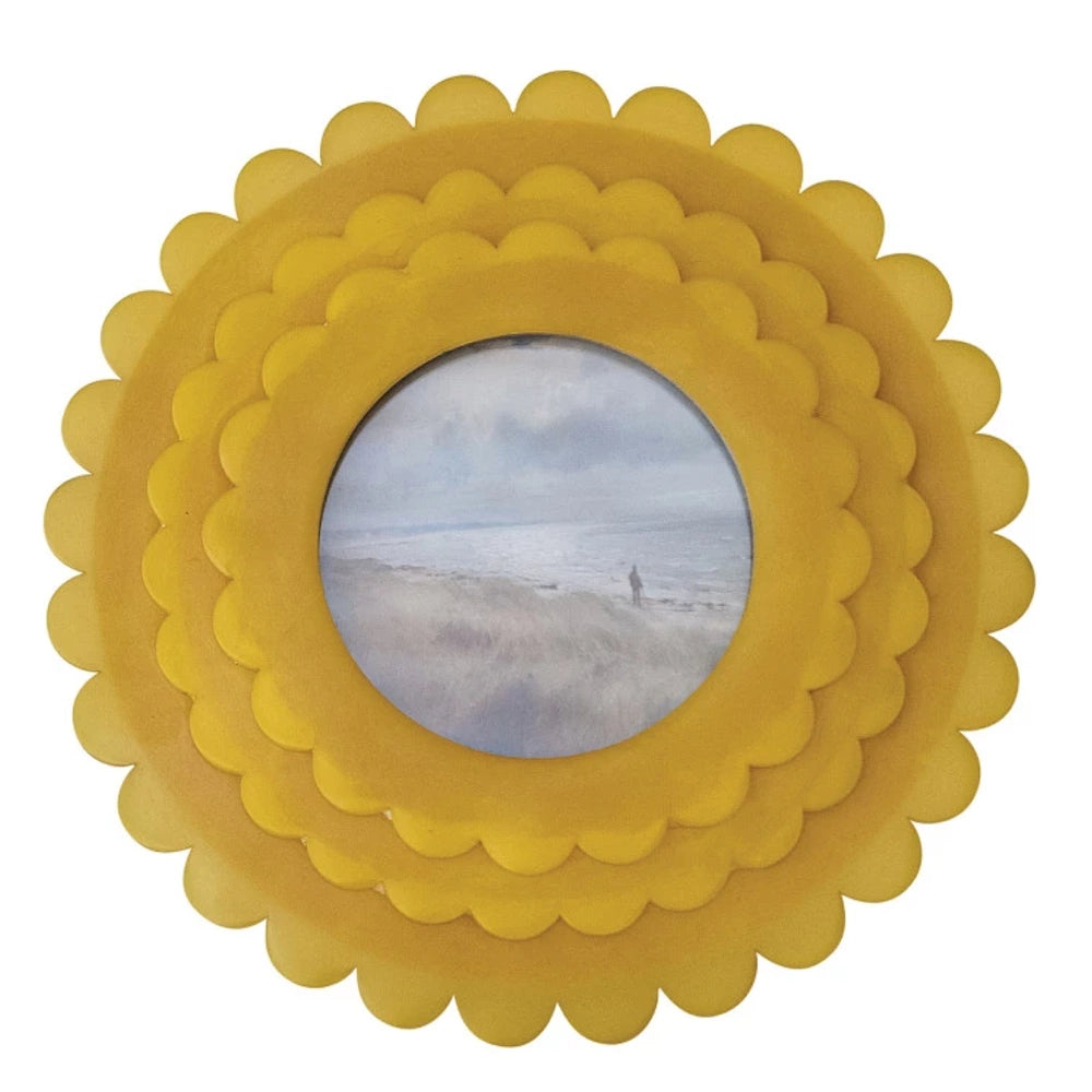 Handmade circular yellow resin photo frame with triple-layered scalloped edges, featuring a landscape photo of a beach.
