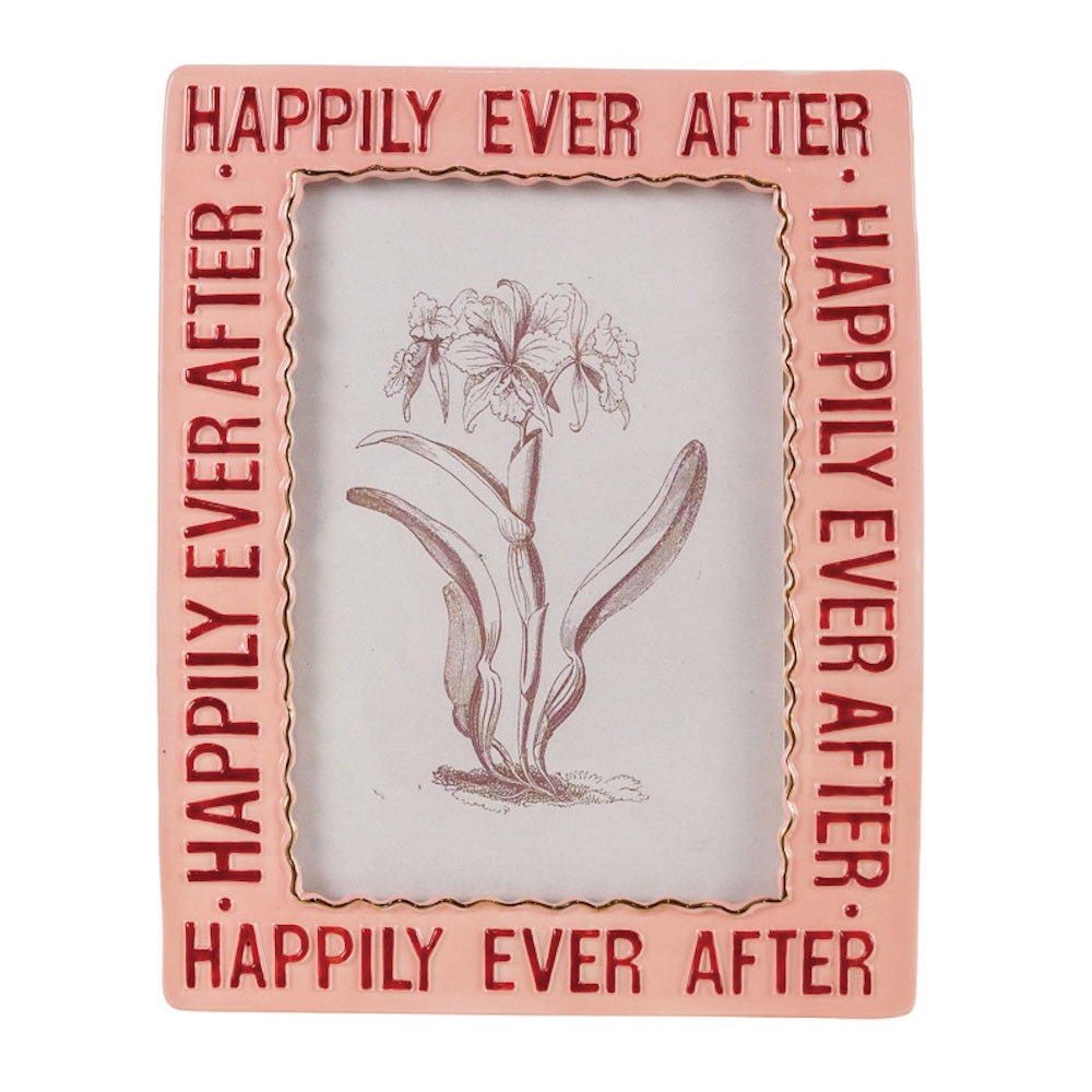 A pink rectangular picture frame embossed with "HAPPILY EVER AFTER" in red text, holding a floral sketch.