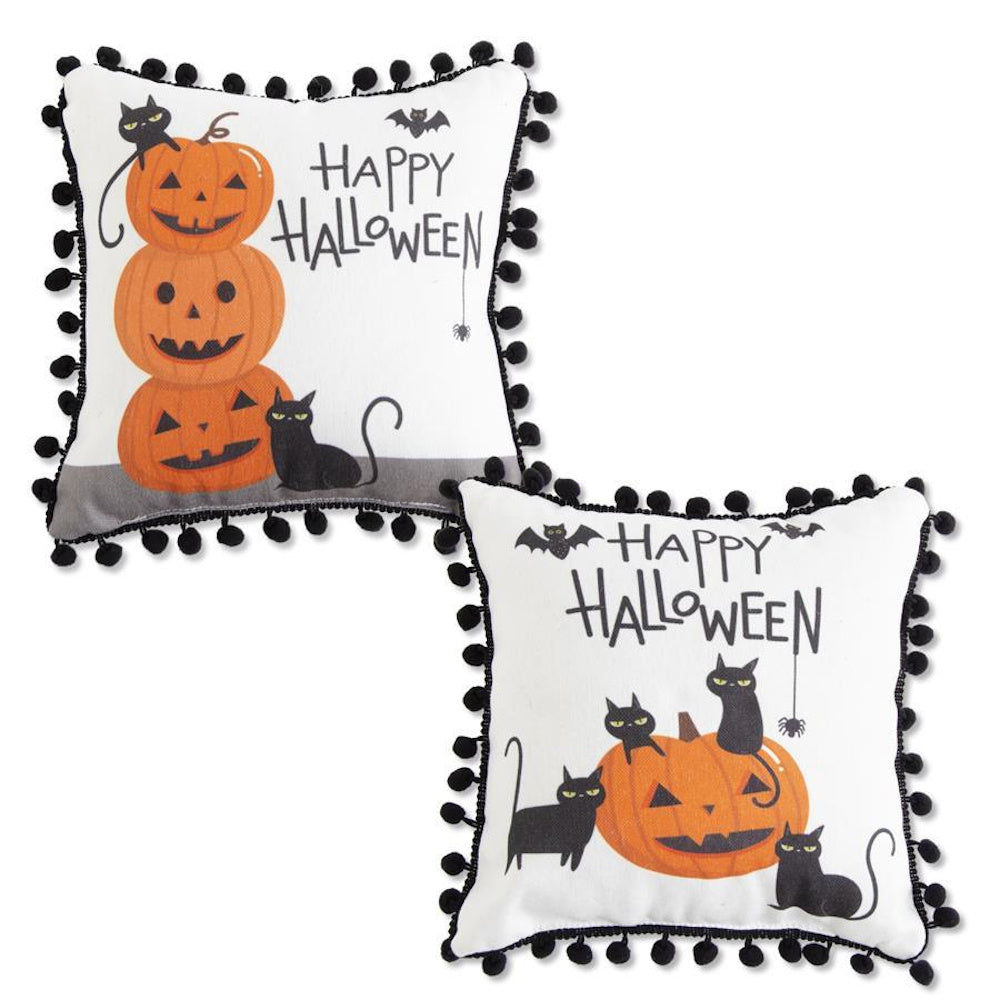 Two square white Halloween pillows with black pom-pom trim, featuring black cats, jack-o'-lanterns, and bats.