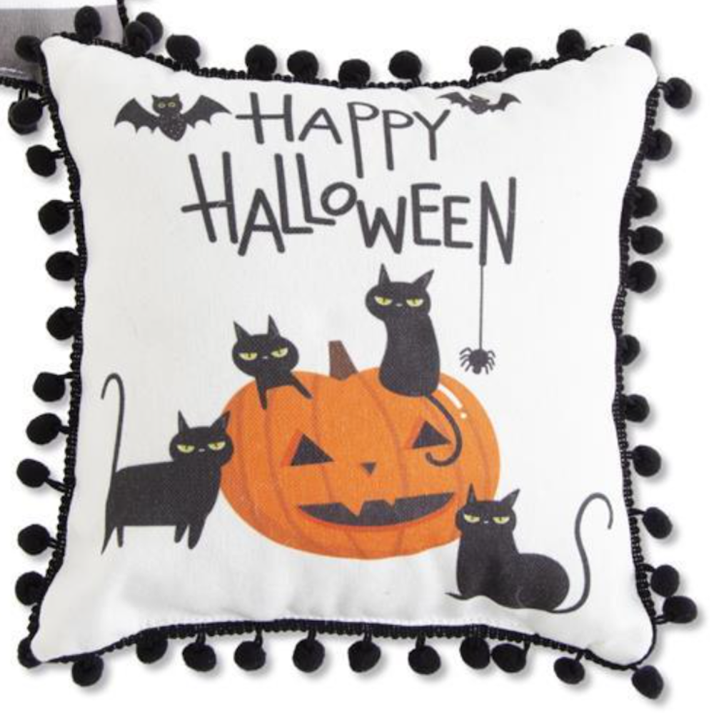 Happy Halloween pillow with black pompoms, featuring four black cats around a jack-o'-lantern.