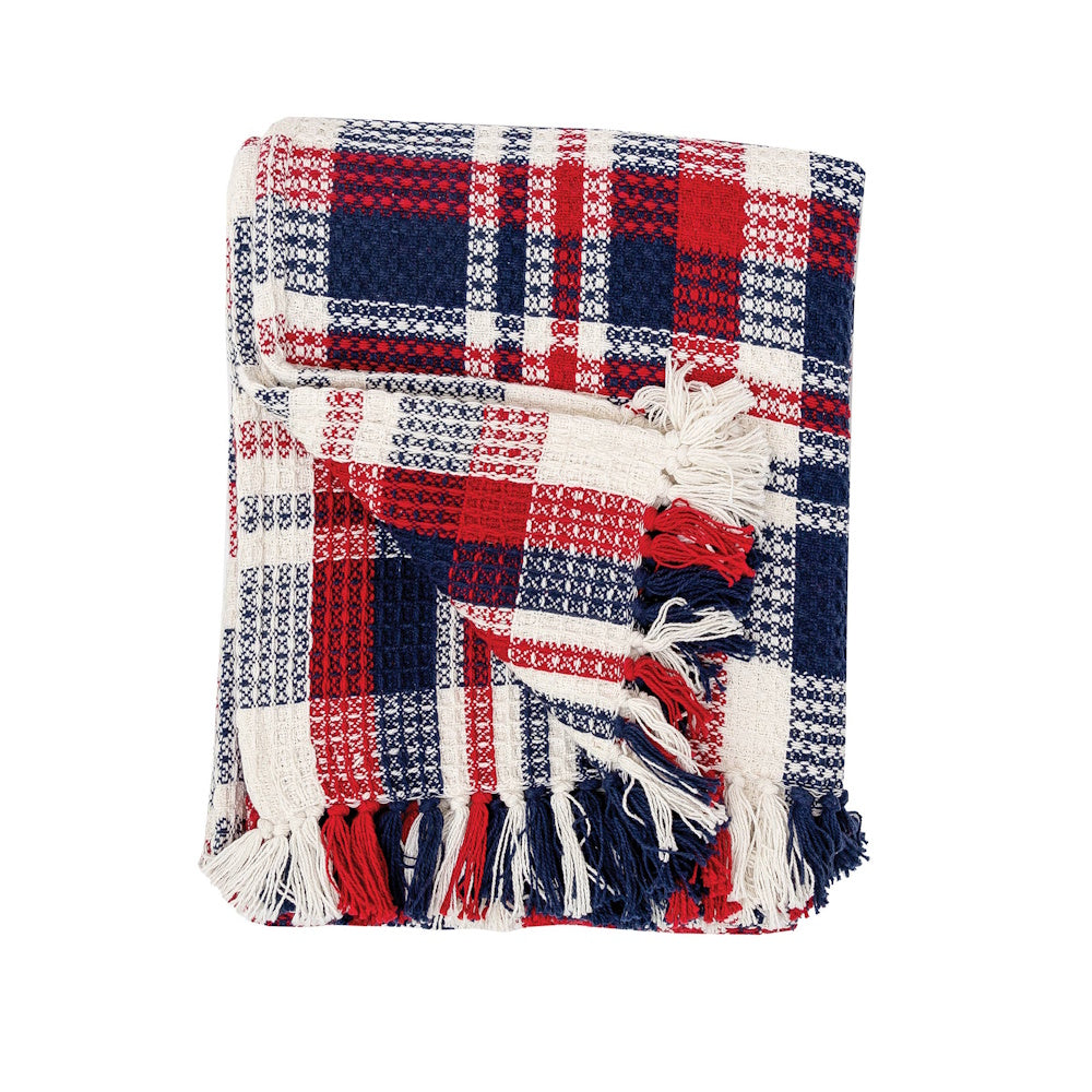 Red, white, and blue plaid throw blanket with a textured waffle weave and fringed edges, folded neatly.