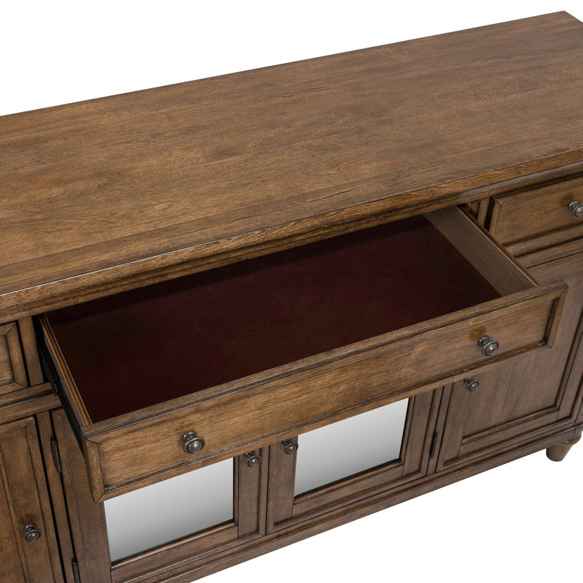 Close-up of a Harrison Heights wood buffet featuring an open drawer with a felt-lined interior and bronze hardware.