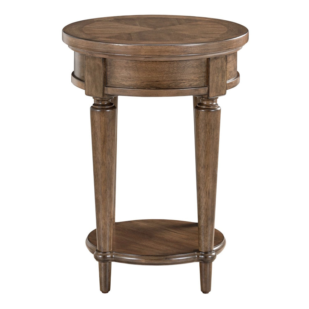 Round wood chairside table in brown finish with turned legs and a lower storage shelf.