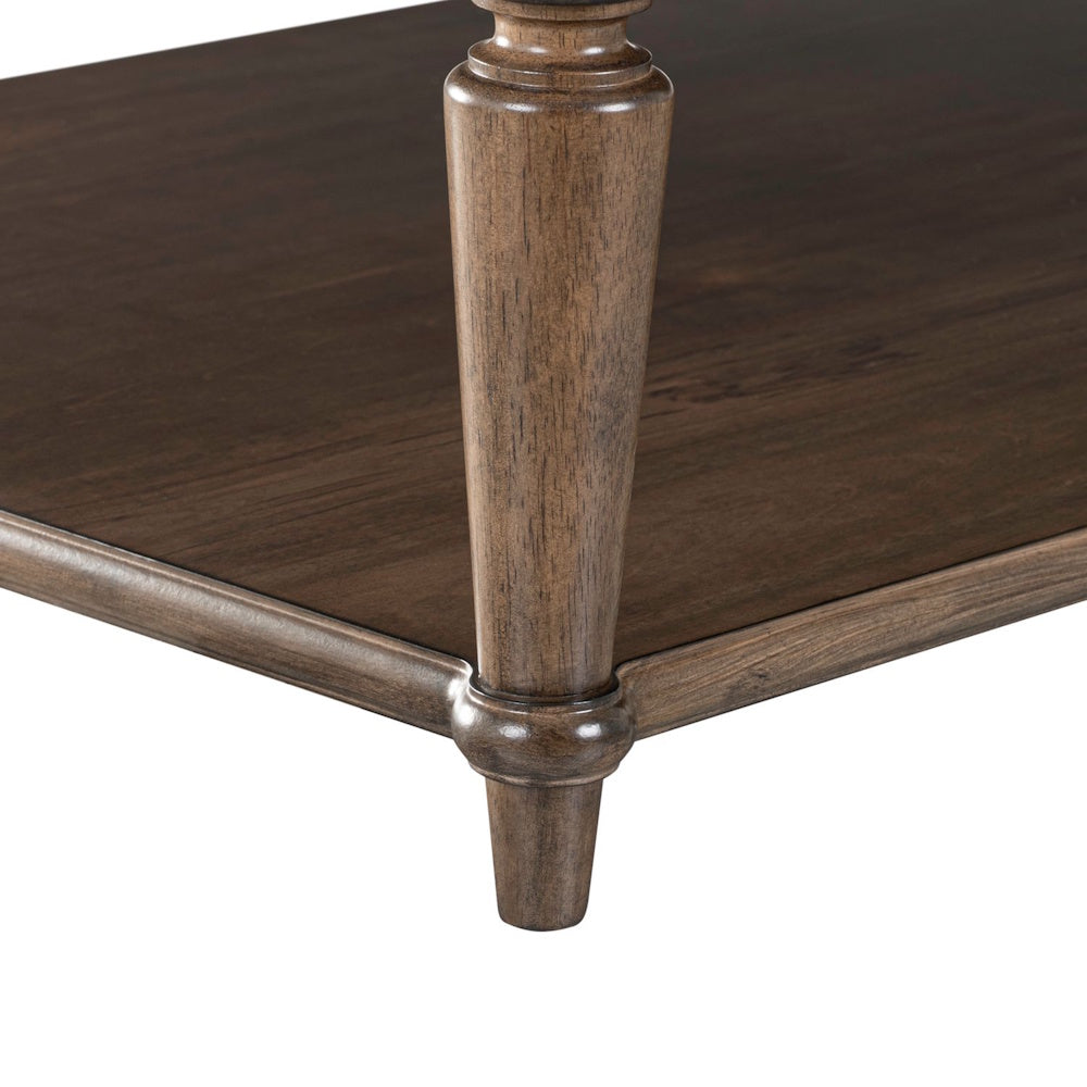 Wooden cocktail table base featuring a turned leg, lower shelf, and classic brown finish.
