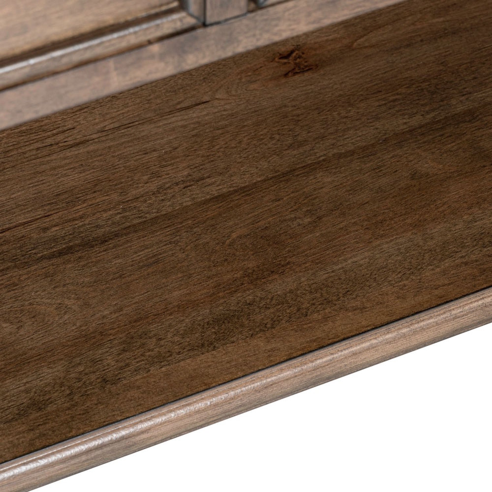 Close up of the rich dark brown wood grain finish on a wooden cocktail table shelf.