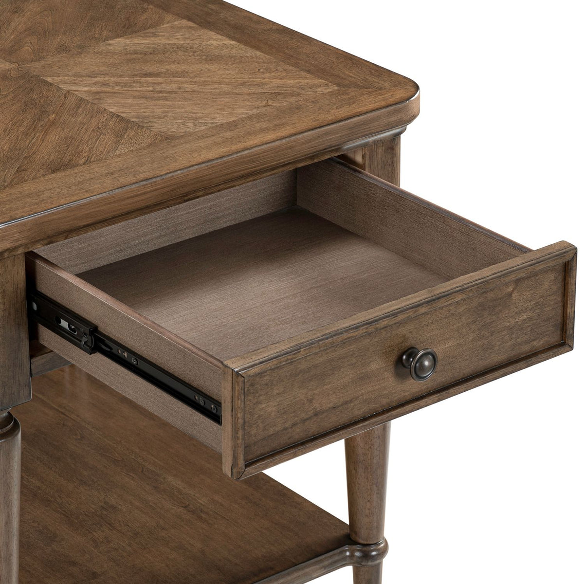 Wooden end table with an open drawer showing standard metal glides and a round bronze pull knob.