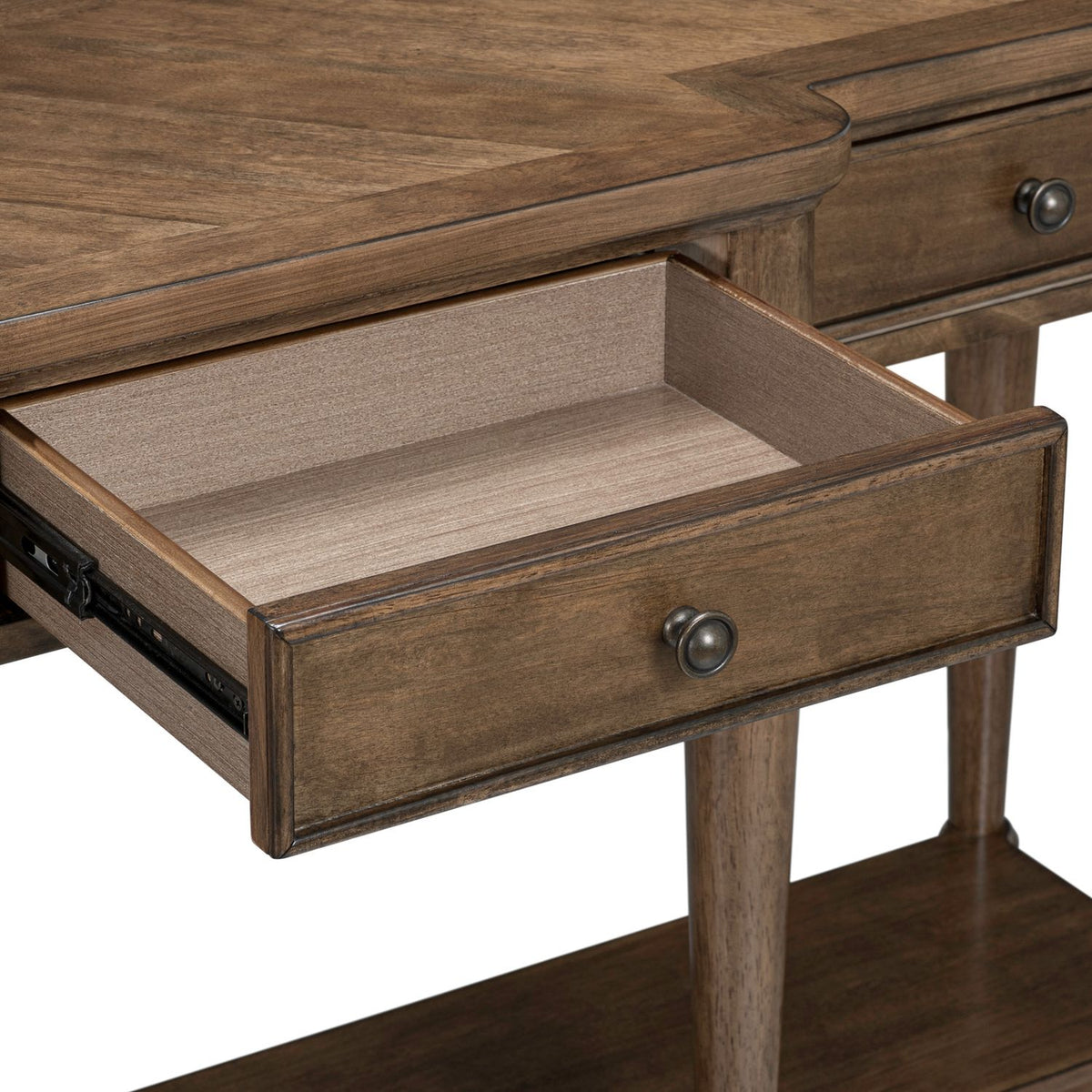 Close-up of an open wooden drawer on a brown console table with a metal knob and smooth roller glides.