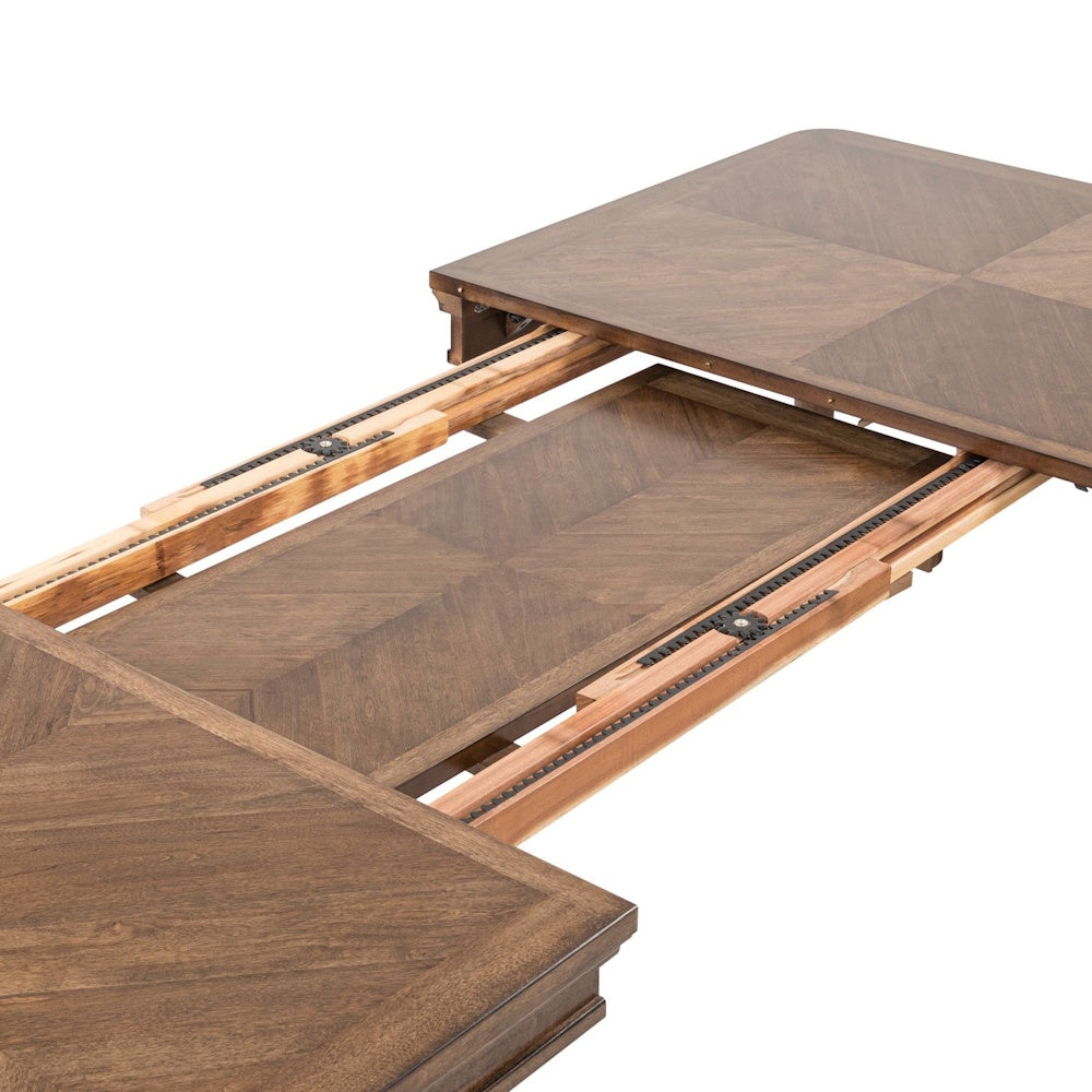 Close-up of a Harrison Heights rectangular wood dining table with an open leaf extension and gear-driven slides.