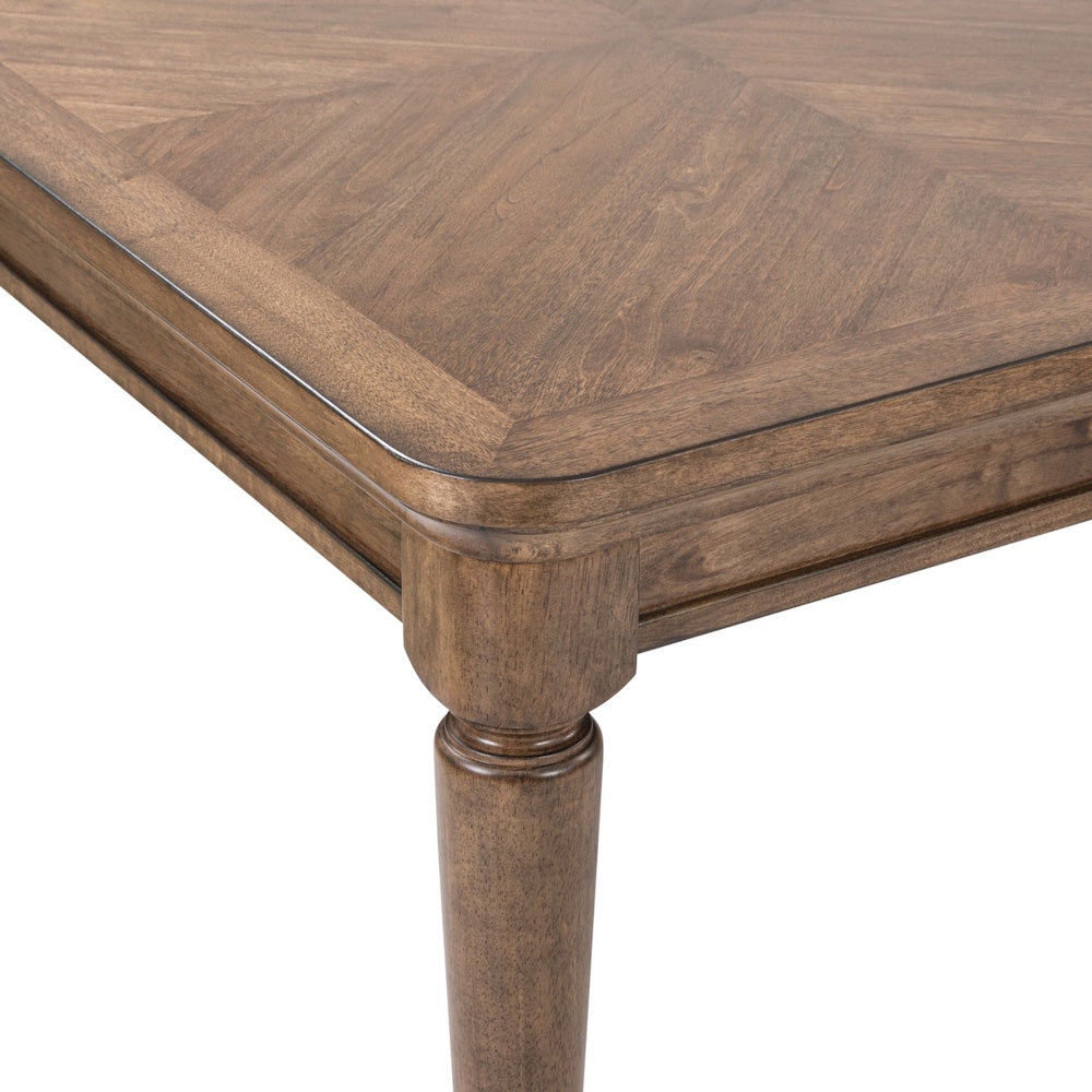 Close-up of a Harrison Heights rectangular wood dining table featuring a walnut finish, clipped corner, and tapered leg.