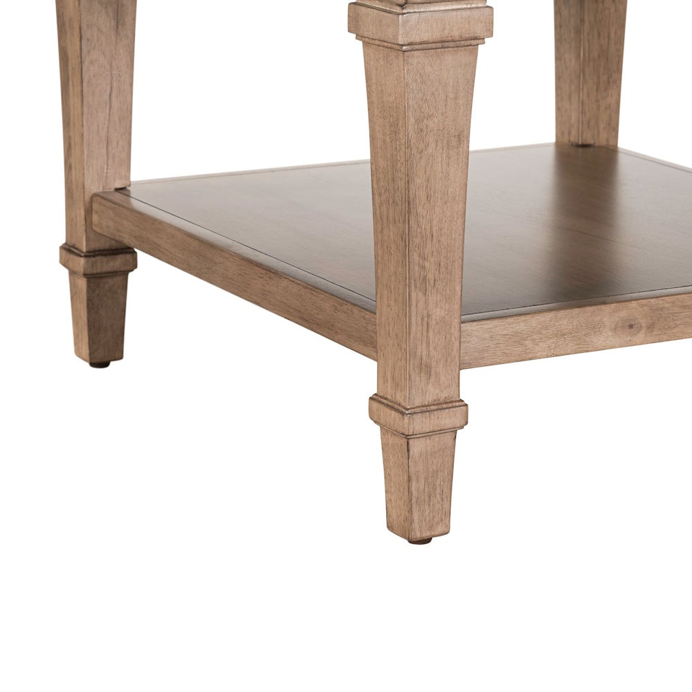Close-up of wood end table base with lower shelf and tapered legs in a natural finish.