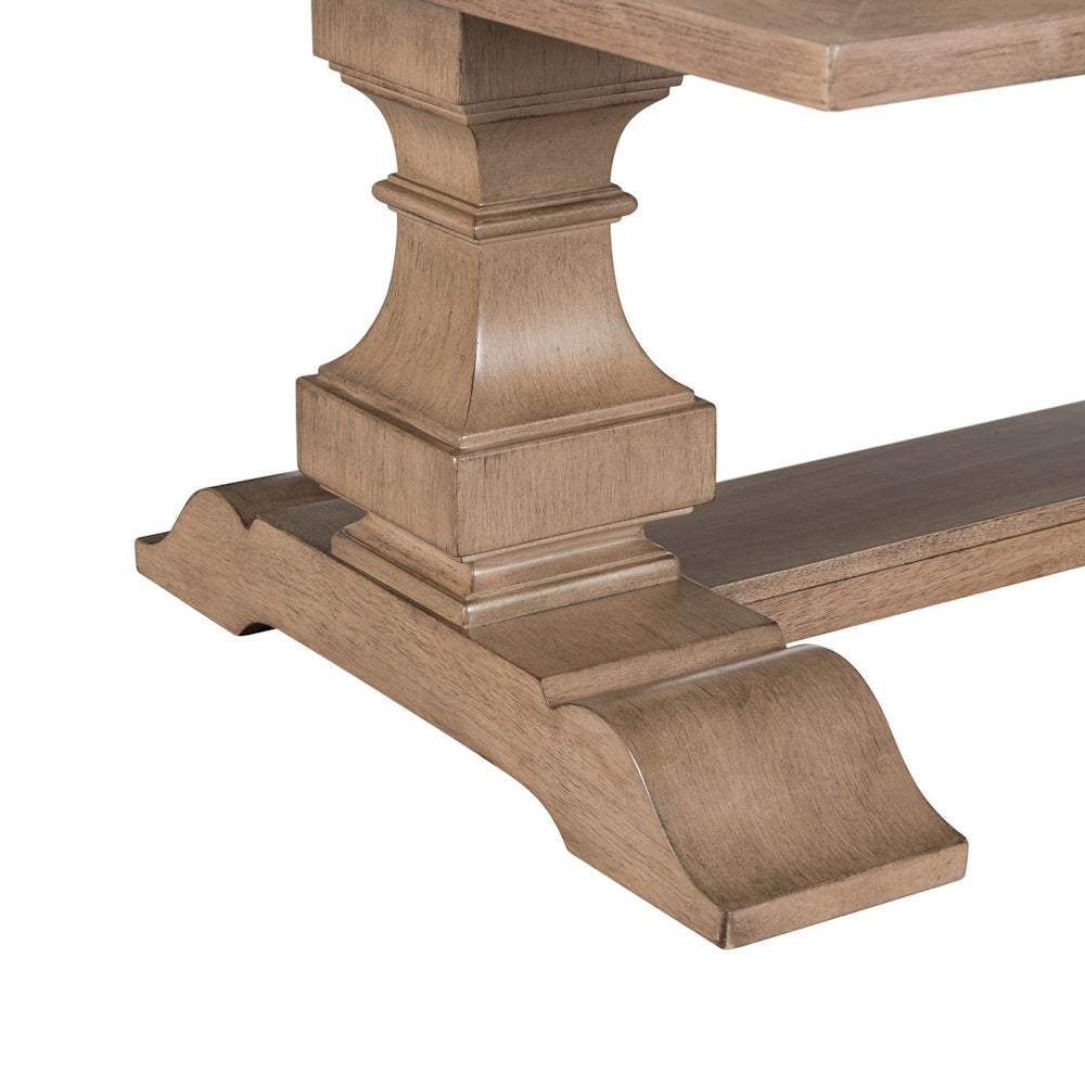 Close-up of wood cocktail table pedestal base with carved details and natural finish.