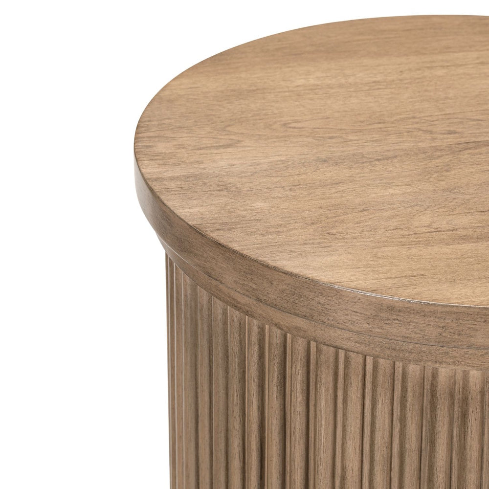 Close-up of round wood chairside table top with fluted base and warm farmhouse finish.
