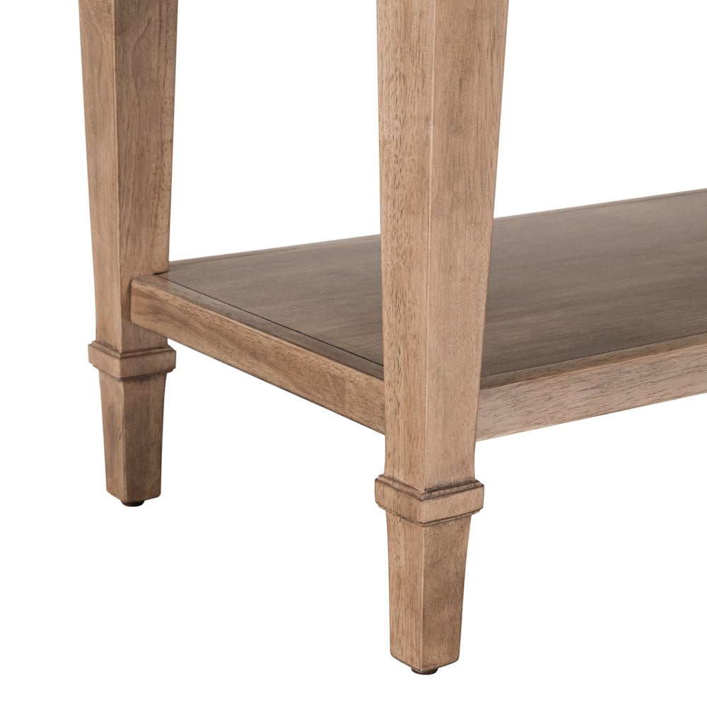 Close-up of light wood sofa table legs and lower shelf with farmhouse style detailing.