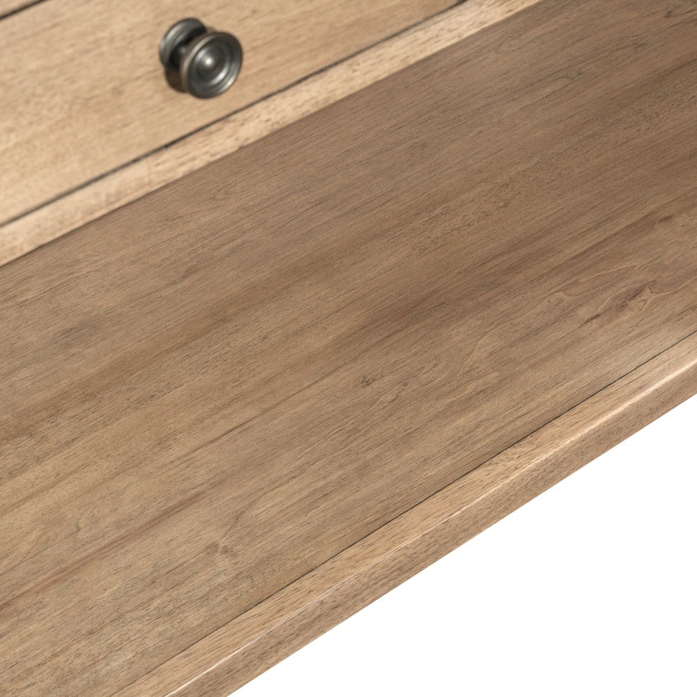 Close-up of light wood sofa table shelf with natural wood grain and farmhouse style finish.