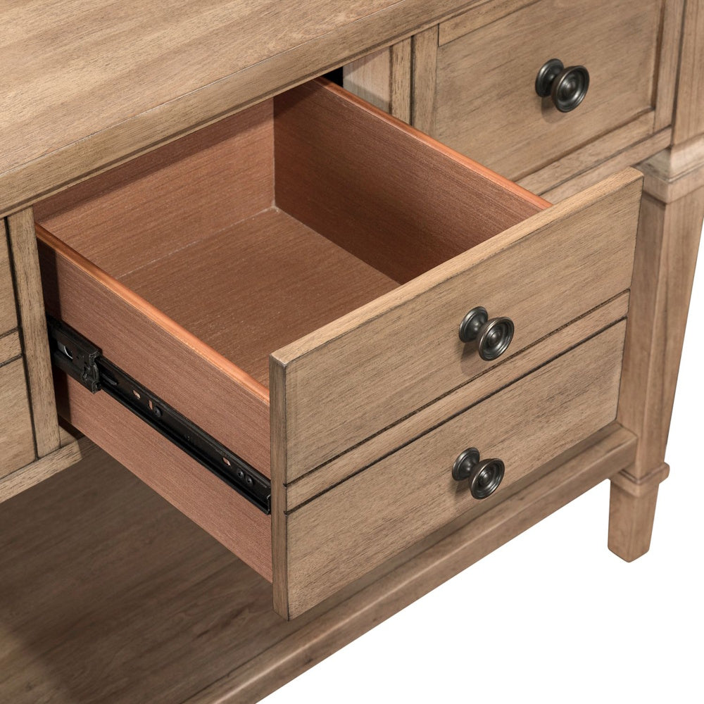 Close-up of open drawer on light wood sofa table with metal glides and farmhouse style design.