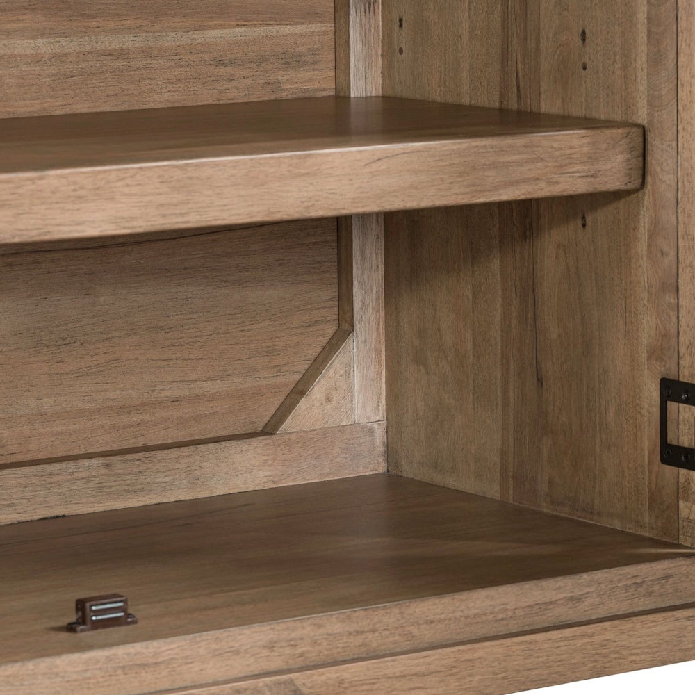 Close-up of light brown wooden shelves inside a console with natural grain and a magnetic door latch.