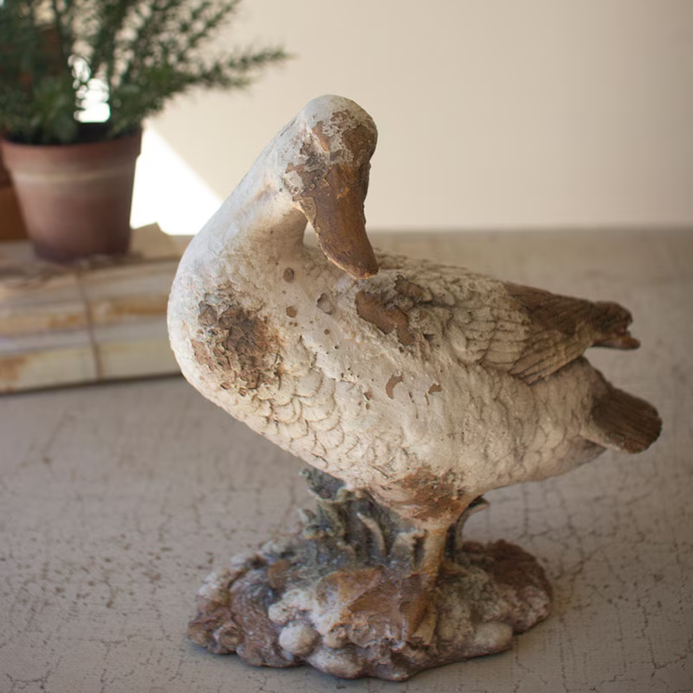 Rustic duck statue with head turned to the side, featuring a distressed, weathered concrete finish.