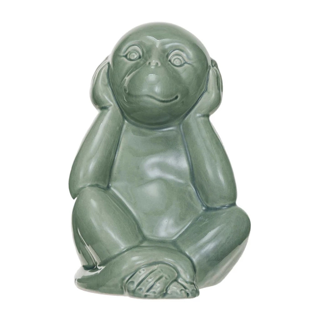 Green stoneware monkey figurine in a "hear no evil" pose with hands over ears and a glossy finish.