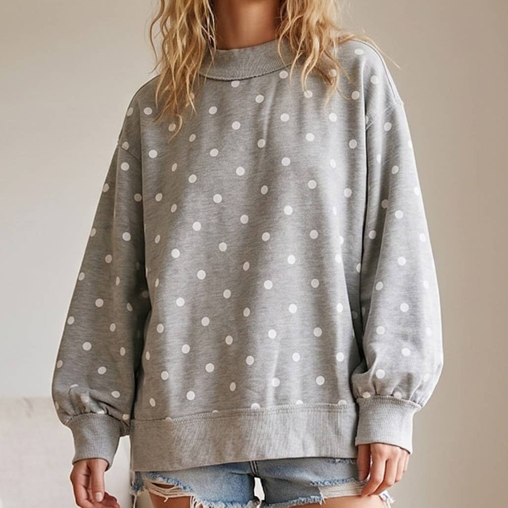 Oversized heather grey pullover with white polka dots, a mock neckline, and gathered ribbed cuffs.