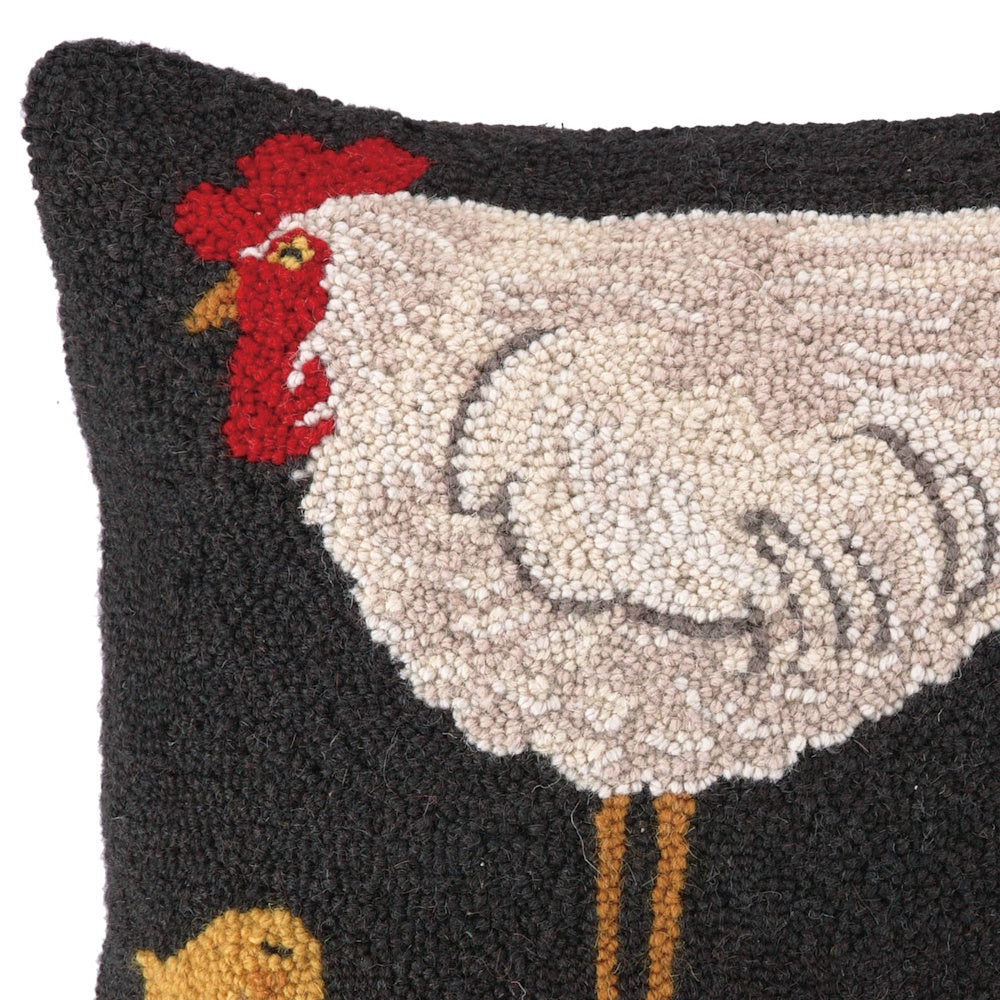 Hand-hooked decorative pillow featuring a white hen with a red comb and a small yellow chick on a dark charcoal background.
