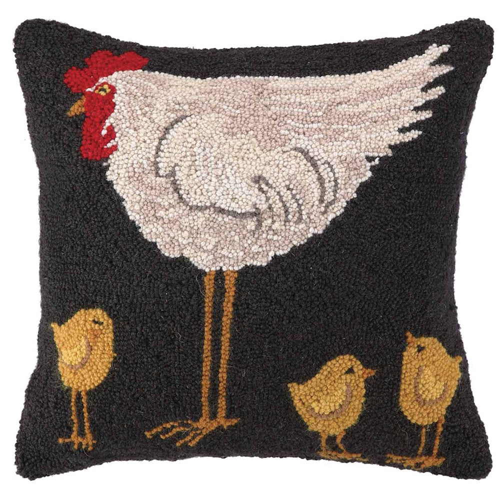 Hand-hooked decorative pillow featuring a folk art white hen and three yellow chicks on a dark charcoal background.